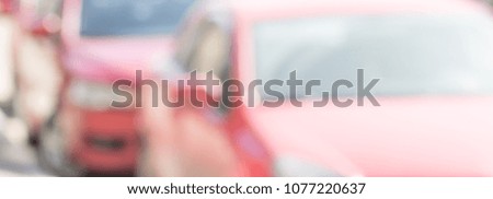 Blurred background with silhouettes of cars. 