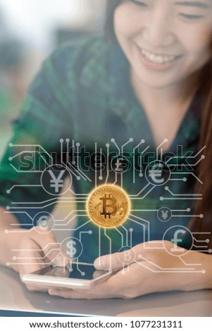 Closeup Asian businesswoman hand using the smart mobile phone with Bitcoins mockup over the Abstract photo of FINTECH connection hologram in workplace co-working space,blockchain and bitcoin concept