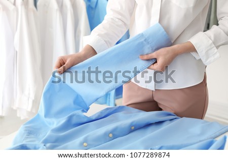 Employee working at dry-cleaner's Royalty-Free Stock Photo #1077289874