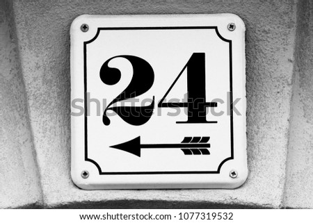 House number 24 on white plate