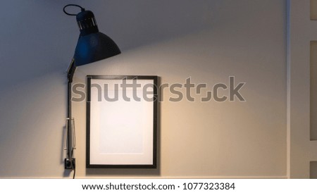 light lamp with white frame on wall