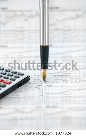 Photo of calculator, fountain pen and stock newspaper