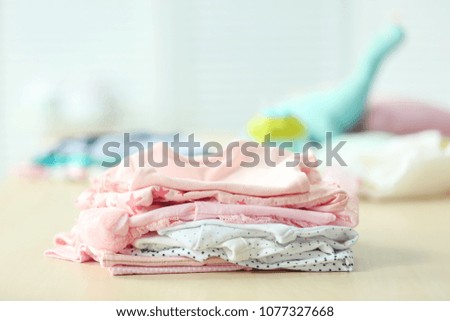 Pile of baby clothes on table