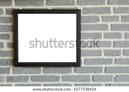 Black natural wooden frame on bricks wall. Mock up blank poster picture frame on brick wall.