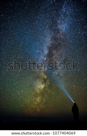 A glance into infinity.  Milky Way and the silhouette of a man looking into the distance.