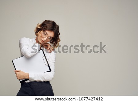 woman with folder, emotions, gray background                            