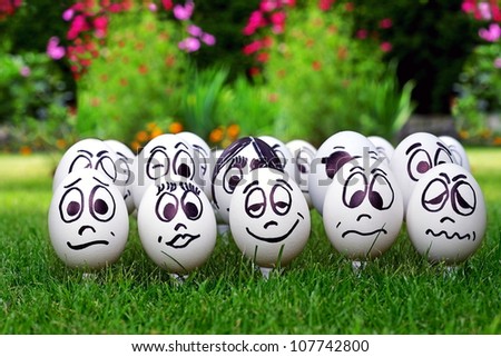 Garden party and many white eggs with funny faces