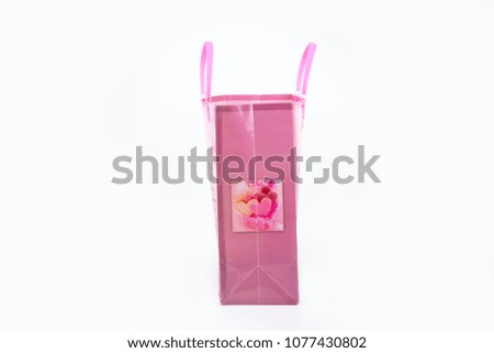 isolated pink plastic bag with pink handles on white background