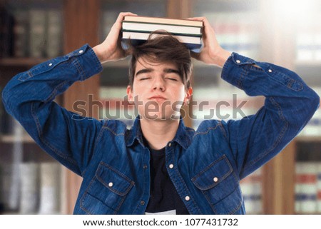 student with books in the library