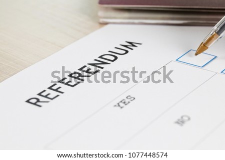 Referendum ballot paper, black pen, and passport on the table. Closeup Royalty-Free Stock Photo #1077448574