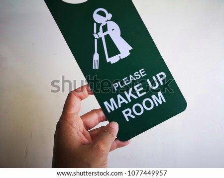 Please make up room sign hanging on door knob.