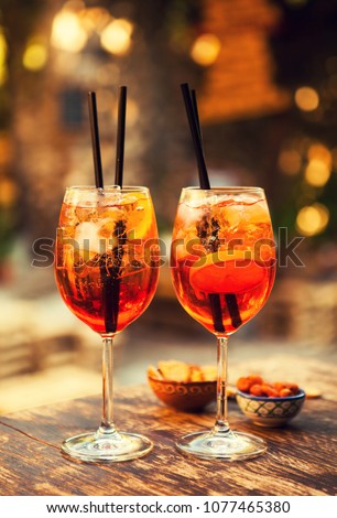 Two glasses of Aperol Spritz cocktails on the table in restaurant, Taormina, Sicily, Italy. Royalty-Free Stock Photo #1077465380