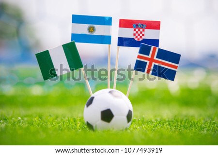 Group D - draw in football match. National Flags of Argentina, Iceland, Croatia, Nigeria. Flags on green grass on football stadium