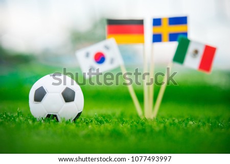 Group F and football ball on green grass. National Flags of Germany, Mexico, Sweden, Korea Republic, South Korea Royalty-Free Stock Photo #1077493997