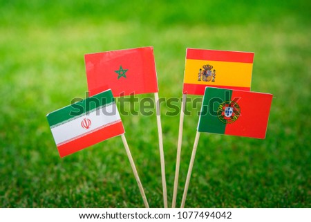 Group B - National Flags of Portugal, Spain, Morocco, IR Iran, Flags on green grass on football stadium