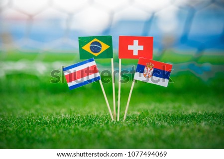 Group E - Russia 2018. National Flags of Brazil, Switzerland, Costa Rica, Serbia. Flags on green grass on football stadium