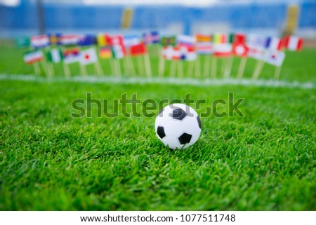 Flags of all football nations on green grass. Football ball, Fans, support photo, edit space. 