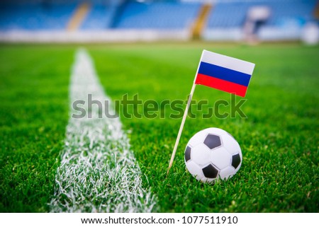 Russia national Flag and football ball on green grass. Fans, support photo, edit space. 