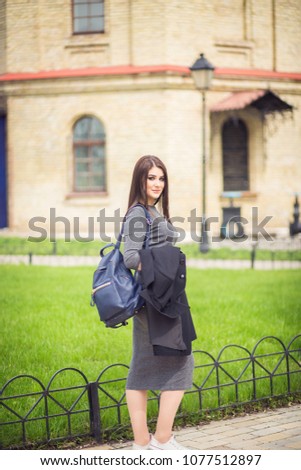 Young beauty girl posing near the old building