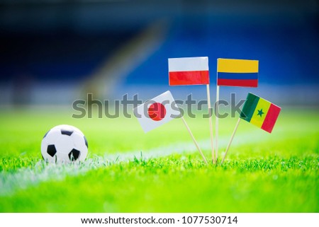 Poland, Senegal, Columbia, Japan national Flag and football ball on green grass. Fans, support photo, edit space. Royalty-Free Stock Photo #1077530714