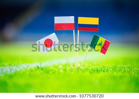 GROUP H draw in Russia 2018  - Poland, Senegal, Columbia, Japan national Flag and football ball on green grass. Fans, support photo, edit space. Original wallpaper for Football World Cup, Russia 2018 Royalty-Free Stock Photo #1077530720