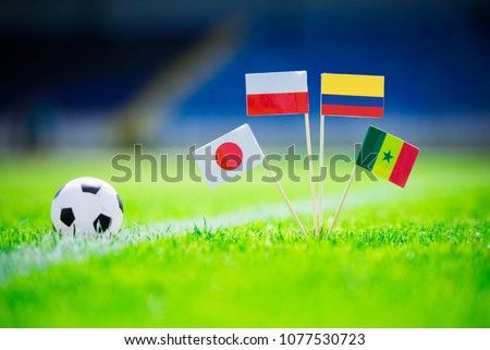 GROUP H draw in Russia 2018  - Poland, Senegal, Columbia, Japan national Flag and football ball on green grass. Fans, support photo, edit space. Original wallpaper for Football World Cup, Russia 2018 Royalty-Free Stock Photo #1077530723