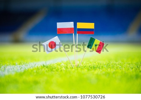 GROUP H draw in Russia 2018  - Poland, Senegal, Columbia, Japan national Flag and football ball on green grass. Fans, support photo, edit space. Original wallpaper for Football World Cup, Russia 2018 Royalty-Free Stock Photo #1077530726