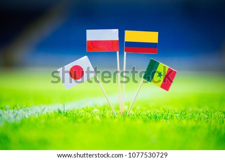 GROUP H draw in Russia 2018  - Poland, Senegal, Columbia, Japan national Flag and football ball on green grass. Fans, support photo, edit space.