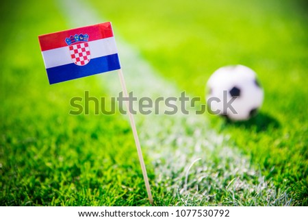 Croatia national Flag and football ball on green grass. Fans, support photo, edit space. 