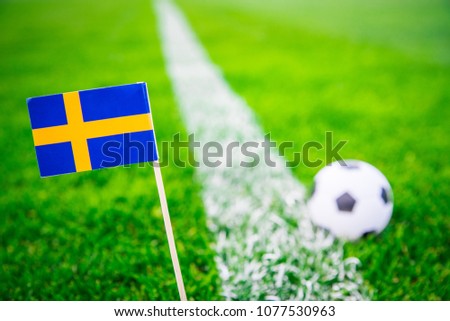 Sweden national Flag and football ball on green grass. Fans, support photo, edit space. 

