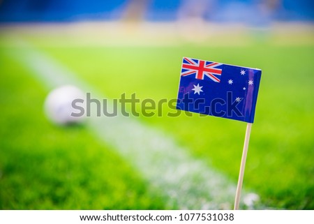 Australia national Flag and football ball on green grass. Fans, support photo, edit space. 