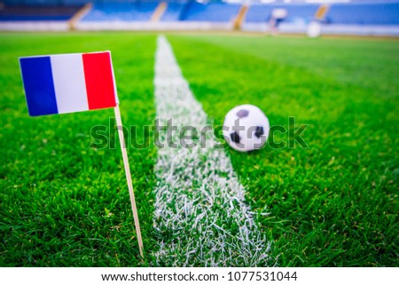 France national Flag and football ball on green grass. Fans, support photo, edit space. 