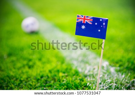 Australia national Flag and football ball on green grass. Fans, support photo, edit space. 