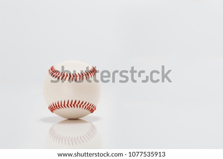 Professional leather baseball on the white background, reflecting in the surface below it.
