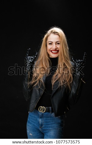 Image of young blonde in leather jacket showing goat gesture
