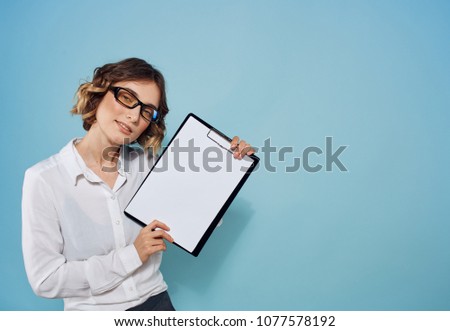 woman with a folder in her hand on a blue background                             