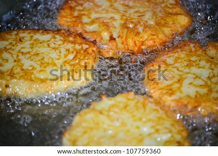 Potato latkes for Hanukah frying in oil