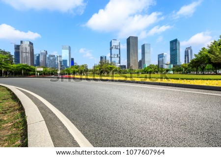 empty asphalt road and modern commercial office buildings in shenzhen