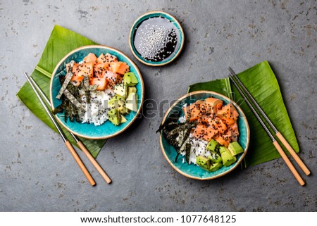 Salmon sushi bowl or salmon poce with soy sauce. Top view