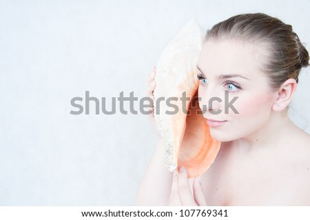 Portrait of a beautiful girl a conch shell