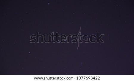 Plane on the starry sky, a long exposition