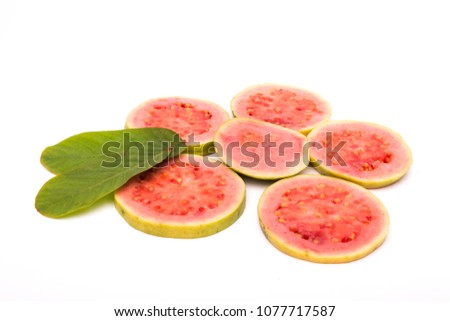 Slices of fresh pink guava fruit isolated on white background