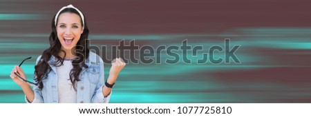 Millennial woman celebrating against teal and dark red motion blur