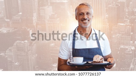 Cafe owner with coffee and cake against blurry skyline