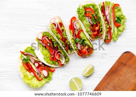 Fresh vegetarian tacos on white wooden background. From above. Top view