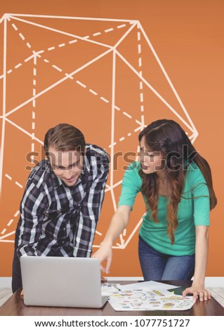 Business people at a desk pointing at a computer against orange background with graphic
