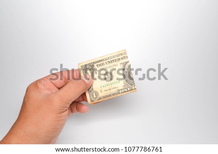 hand hold one dollar bills on white background. Selective focus.