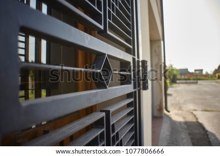 Armored door in artisan iron used for security reasons to protect a home. Royalty-Free Stock Photo #1077806666