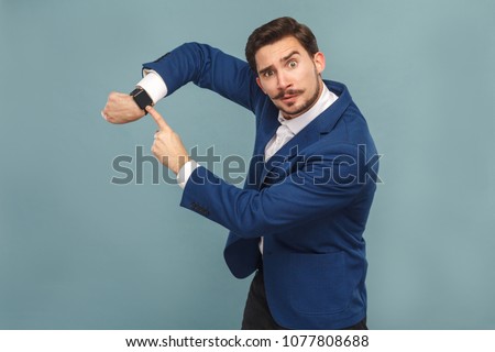 Time is gone! Boss showing watch bad manager. Business people concept, richly and success. Indoor, studio shot on light blue background Royalty-Free Stock Photo #1077808688