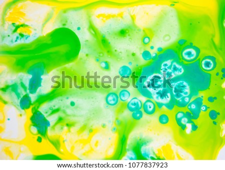 Fluid art watercolor party background. Cosmic music poster. Creative artwork hippie wallpaper in yellow green color.